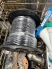 Industrial and automotive items, small tire, cabling, muffler, brake rotor, large 40 lb dumbbell, and more - 3
