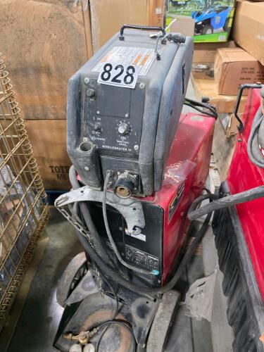 Lincoln Electric MobileMaster IV welding machine with a black control panel and red lower housing.