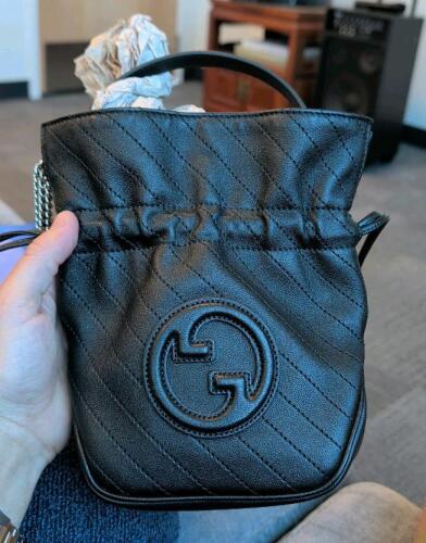 Authentic Gucci GG Blondie mini bucket bag in black quilted leather with diagonal stitching and an interlocking G logo