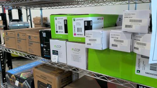 shelf of Konica Minolta toners, lexmark, Canon and other