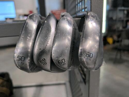 Four golf wedges three appear new Titleist and one Callaway used