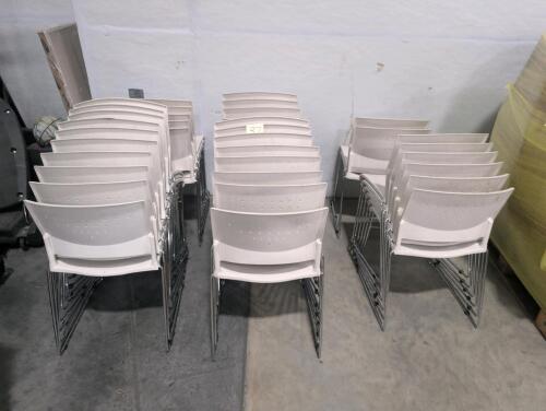 Approximately 37 stacking chairs, used