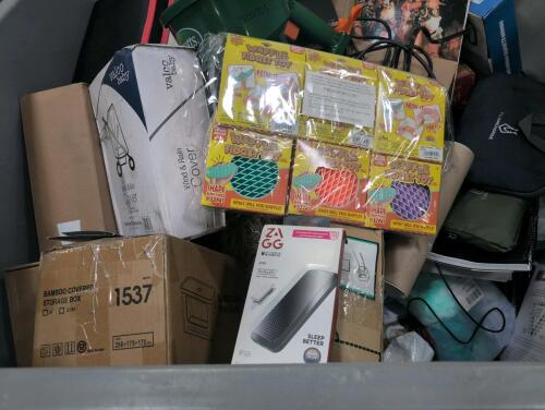 Storage box, swaddle up, spreader, camera tripod, magnet, cables, pure companies golf tees, books, and