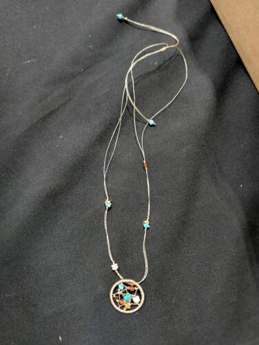 360 boho-style woven cord necklace featuring a circular dreamcatcher-style pendant accented with small turquoise and earthy gemstone chips